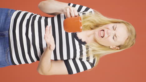 Vertical-video-of-The-woman's-mouth-is-burning-from-the-hot-drink.